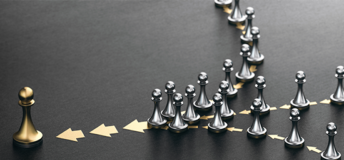 Silver pawns gather together to form a golden piece.