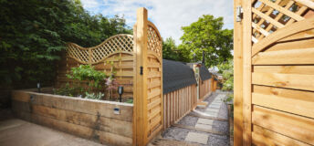 Property, home and exterior of backyard, entrance and door by architecture with walkway. Residential real estate, house or garden fence, trees or path by building patio outdoor on landscape in summer.