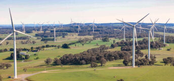 Aerial drone view of an array of large wind turbines at Biala and Gullen Range Wind Farm, Bannister in the Southern Tablelands region of New South Wales, Australia on a sunny day