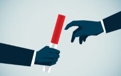 two hands pass a baton