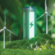 Photo of a green eco-battery surrounded by forestry and windturbines.
