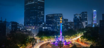 A long exposure of cars circling El Ángel in Mexico City at night