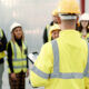 Construction, teamwork and people in meeting for planning, brainstorming and discussion in building. Architecture, engineering and men and women for inspection, property development and project