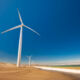 Wind turbines along ocean shore sustainable and renewable energy landscape view