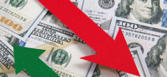 Image of two arrows descending and ascending, respectively, over $100 bills.