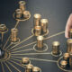 Diversification is the name of the game in an energy crisis Man puting golden coins on a board representing multiple streams of income. Concept of multiplying sources of revenue. Composite image between a 3d illustration and a photography.