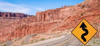 A sign warns of sharp turns ahead on a road in southern Utah.