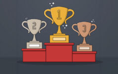 Three trophies with the numbers 1, 2 and 3 on them are placed on a podium