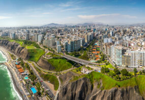 LIMA, PERU: Aerial view of Miraflores town, cliff and the Costa Verde high way