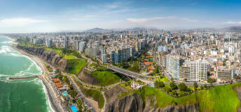 LIMA, PERU: Aerial view of Miraflores town, cliff and the Costa Verde high way