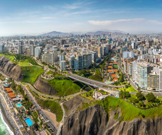 LIMA, PERU: Aerial view of Miraflores town, cliff and the Costa Verde high way