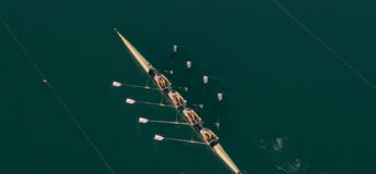 An aerial photo of rowers rowing in a row boat
