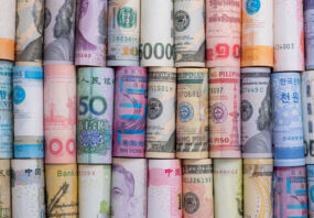Closeup rolled of variety banknote and multi currency around the world. Exchange rate and Forex investment concept.-Image.