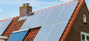 A photo of solar panels installed on a house roof