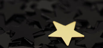 A gold star on a dark grey background