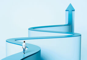A person walking along a winding path that morphs into an arrow that points up