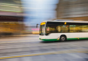 Bus driving on city street, motion blur, panning