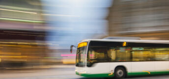 Bus driving on city street, motion blur, panning