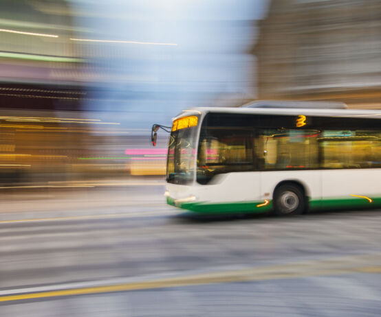 Bus driving on city street, motion blur, panning