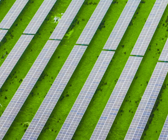 Rows of solar panels installed across farmland, illustrating the connection between renewable energy and rural landscapes, where technology and agriculture work together for a sustainable future.