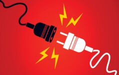 A white plug disconnecting from a black extension cable on a red background